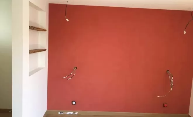 enduit béton ciré rouge fini dans un mur de chambre